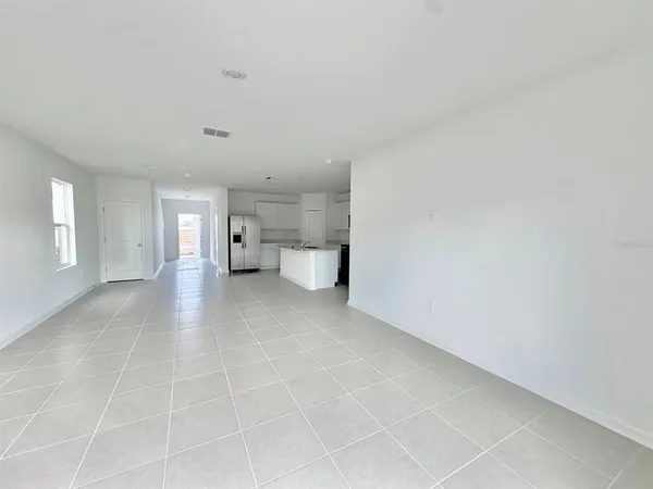 a view of empty room with a window and fire pit
