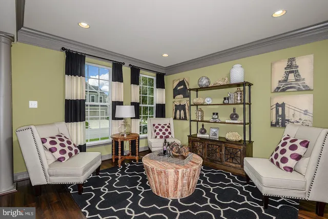 a living room with furniture and a painting on the wall