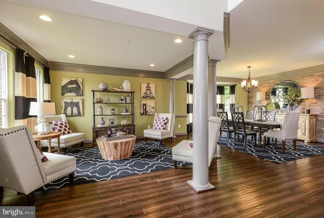 a living room with lots of furniture and wooden floor
