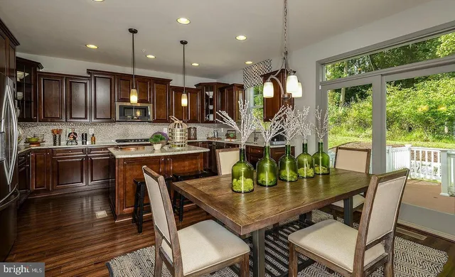 a kitchen with a dining table chairs and stove