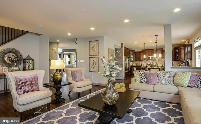 a living room with furniture and kitchen view