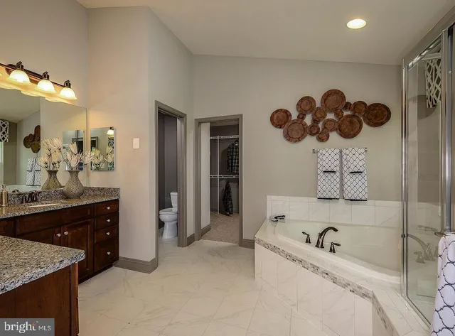 a bathroom with a bathtub sink and mirror
