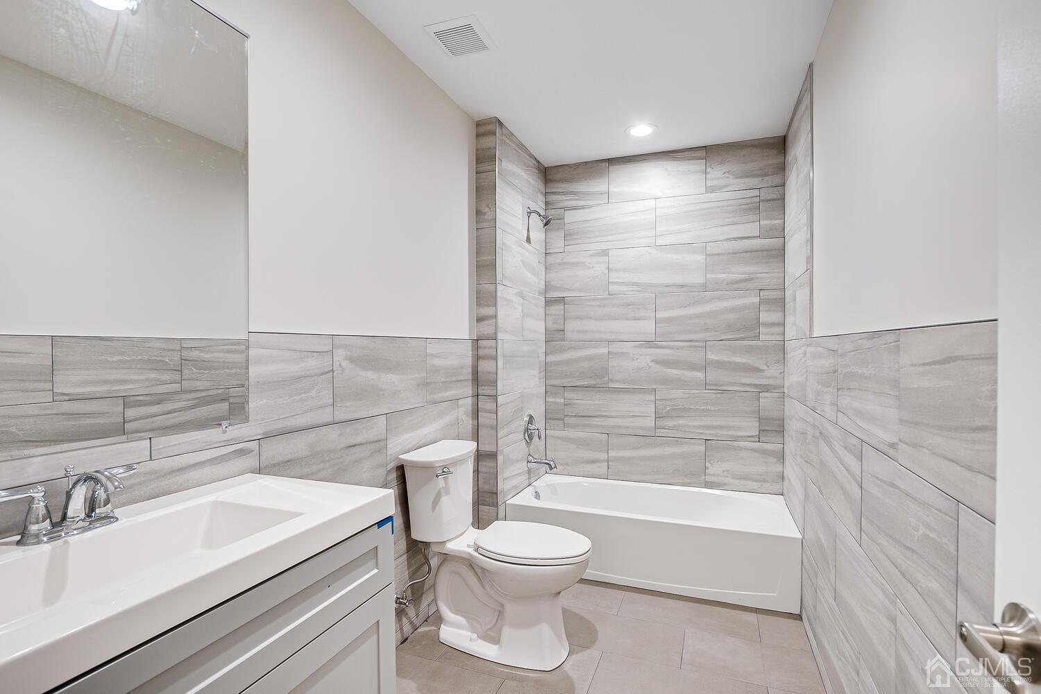 47 West Hill Road Colonia, NJ 07067 - Photo 11 of 18 a bathroom with a toilet a sink and a bathtub