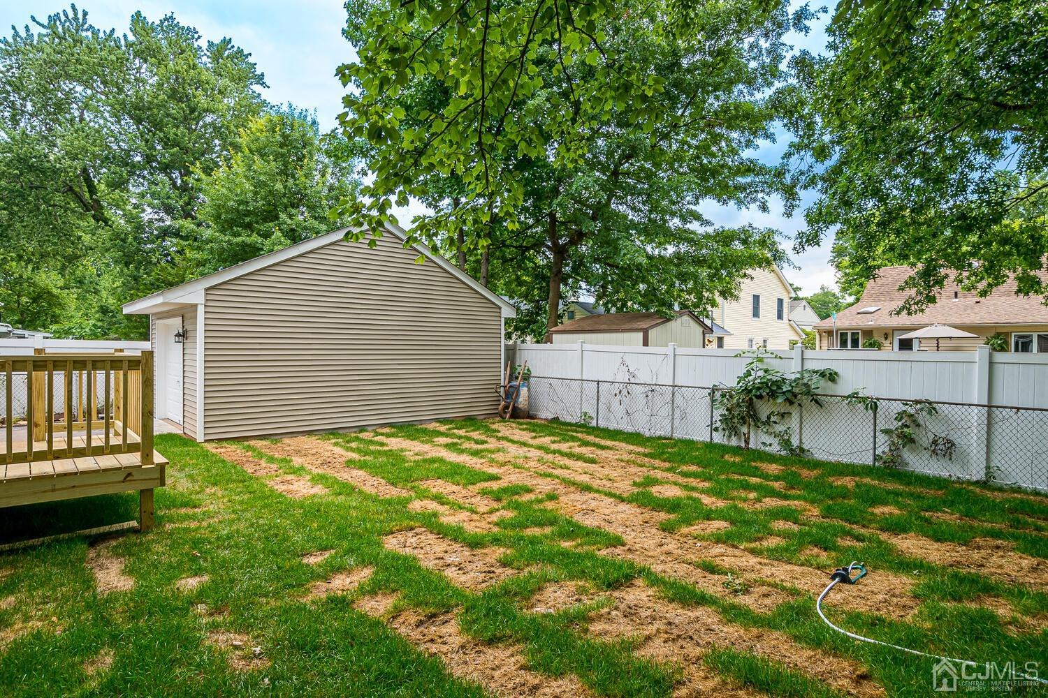47 West Hill Road Colonia, NJ 07067 - Photo 14 of 18 a backyard of a house with table and chairs