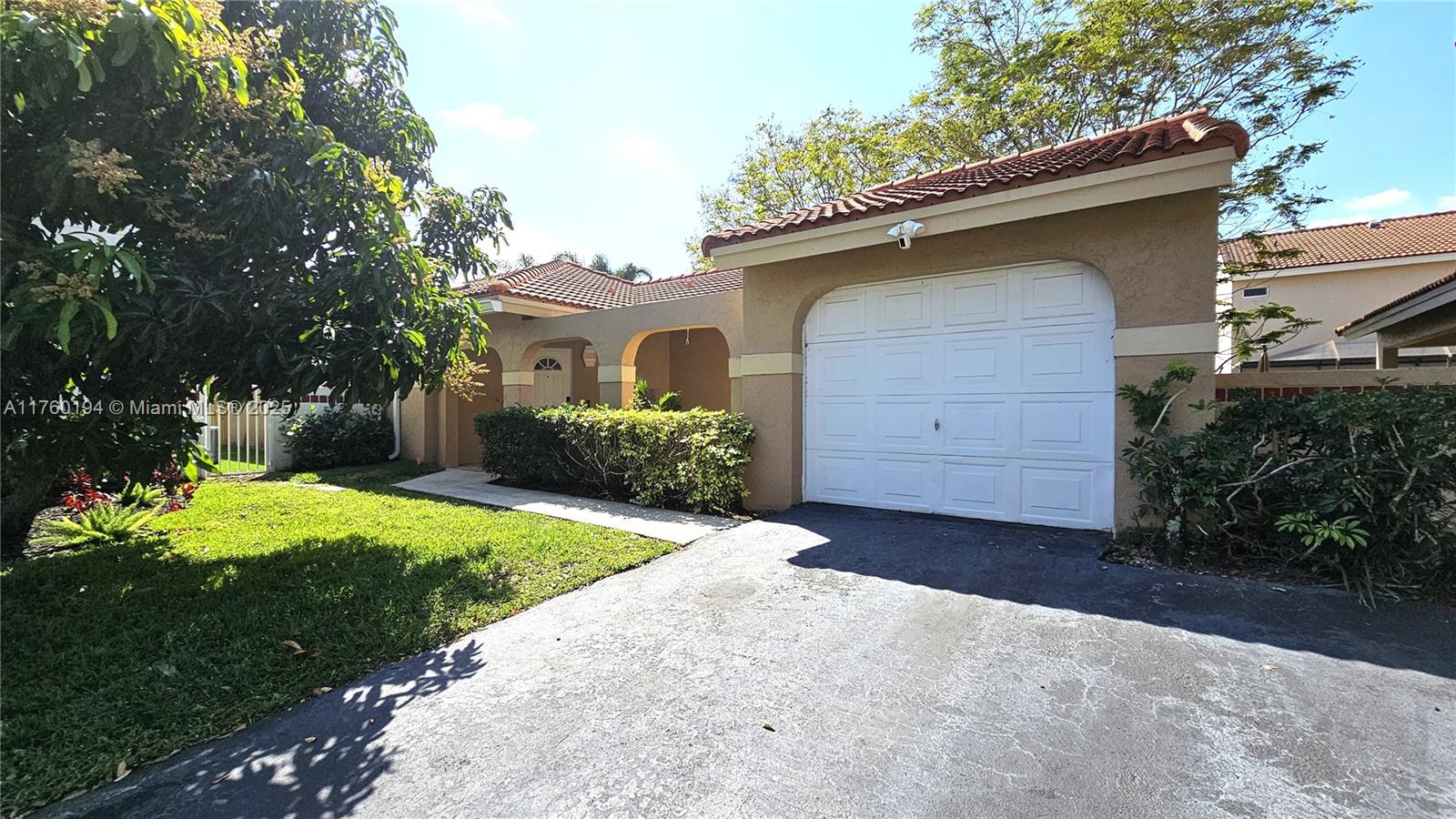 1350 Seagrape Circle Weston, FL 33326 - Photo 20 of 22 a front view of a house with a yard