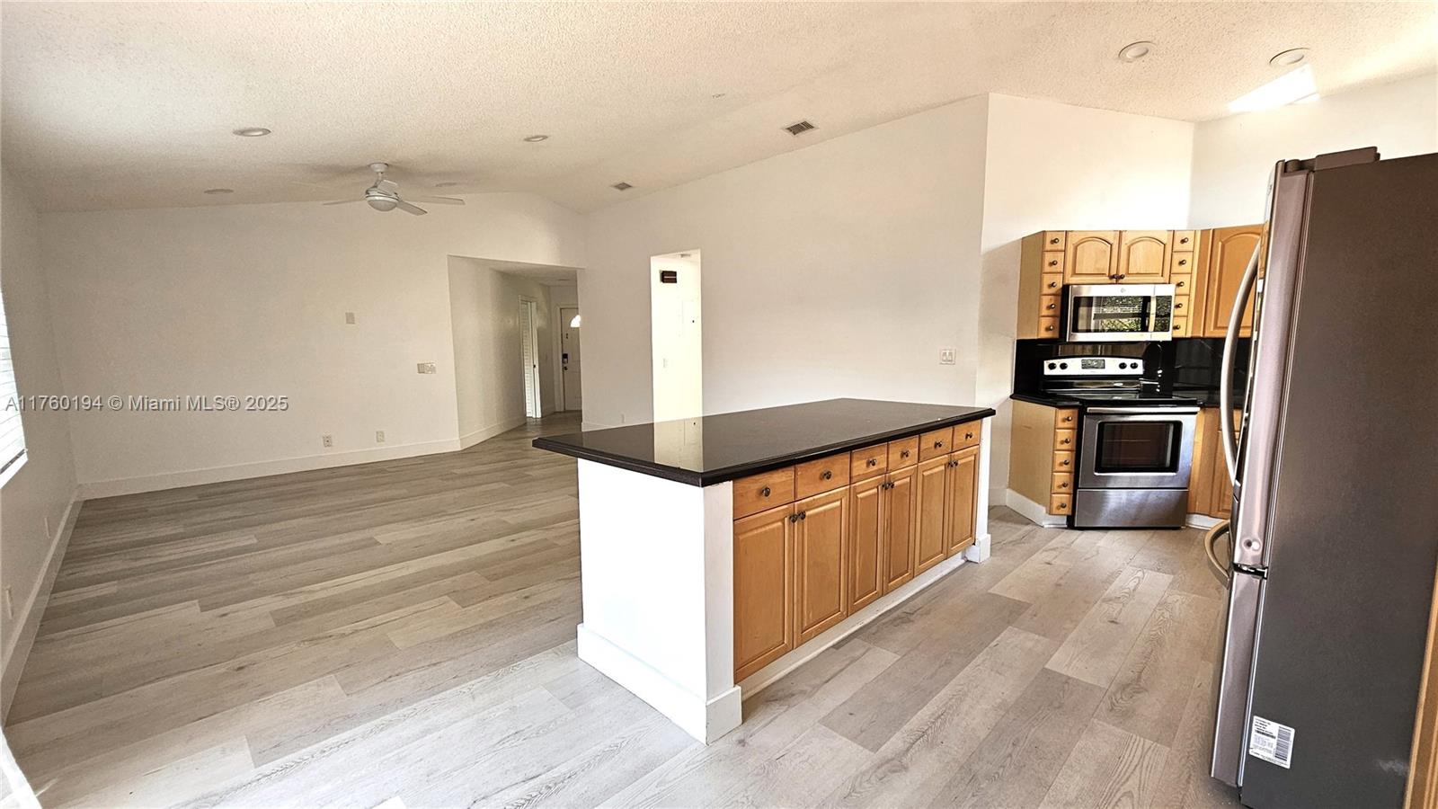 1350 Seagrape Circle Weston, FL 33326 - Photo 4 of 22 a kitchen with stainless steel appliances granite countertop a stove and a refrigerator