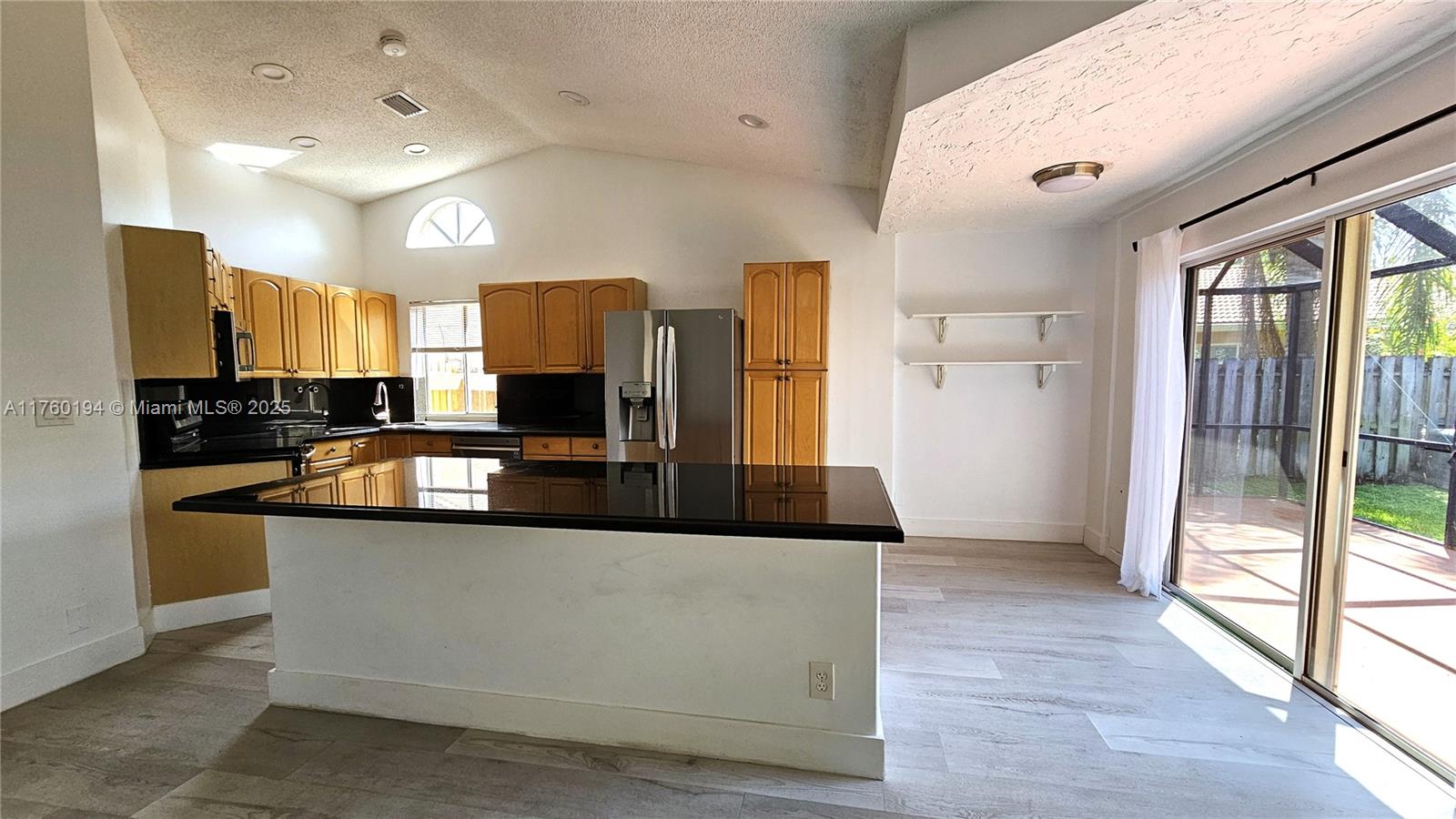 1350 Seagrape Circle Weston, FL 33326 - Photo 5 of 22 a large kitchen with stainless steel appliances granite countertop a refrigerator and a stove top oven