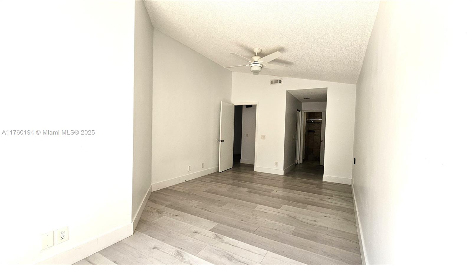 1350 Seagrape Circle Weston, FL 33326 - Photo 8 of 22 a view of a hallway with a chandelier fan
