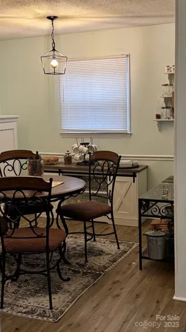 a view of a livingroom with furniture hardwood floor and a ceiling fan