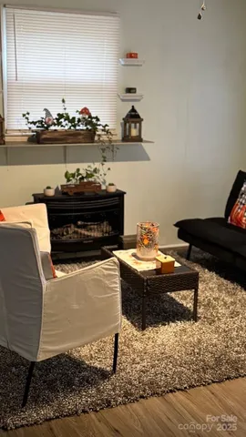a living room with a flat screen tv and a floor to ceiling window