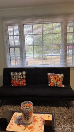 a bed sitting in a bedroom next to a window