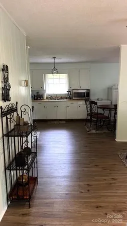 a kitchen with stainless steel appliances granite countertop a sink a stove and cabinets