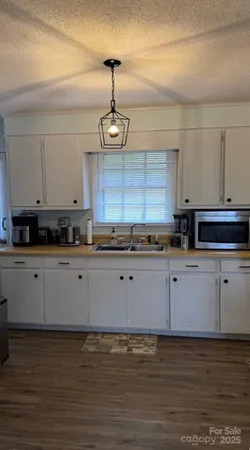 a kitchen with stainless steel appliances granite countertop a refrigerator a stove and a sink