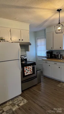 a view of stove top oven and cabinets