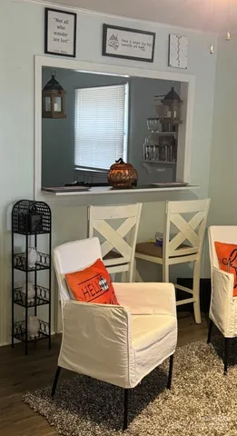 a view of a dining room with furniture and chandelier