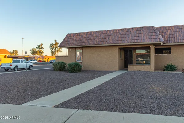 a view of a house with a yard and garage