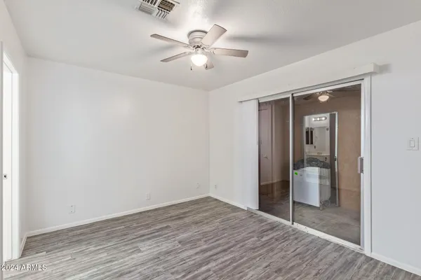 wooden floor in an empty room with a bathroom