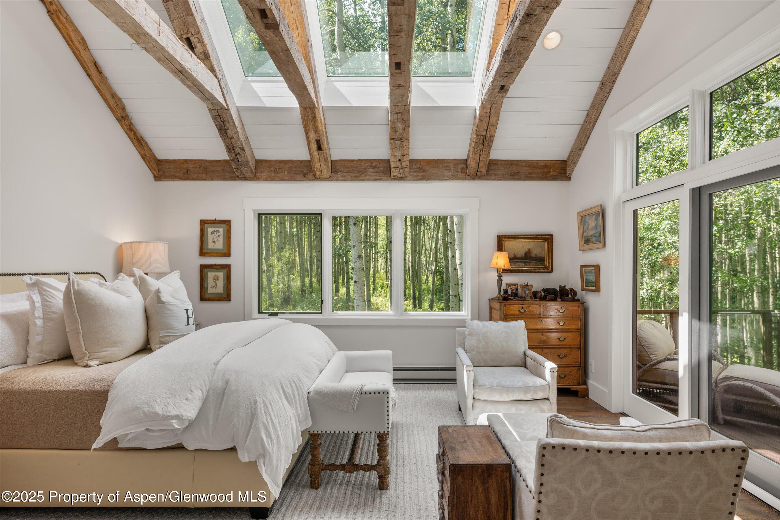 9555 Castle Creek Road Aspen, CO 81612 - Photo 14 of 42 a large bedroom with a large bed and a large window
