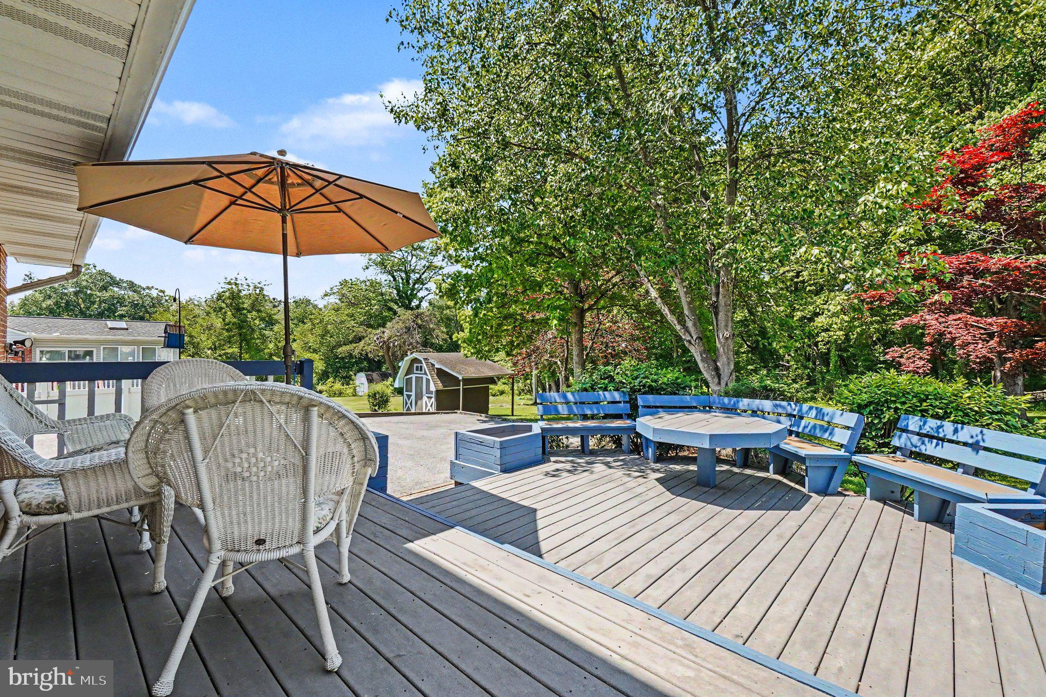 9204 Snyder Lane Perry Hall, MD 21128 - Photo 27 of 42 a view of a roof deck with table and chairs under an umbrella with wooden floor