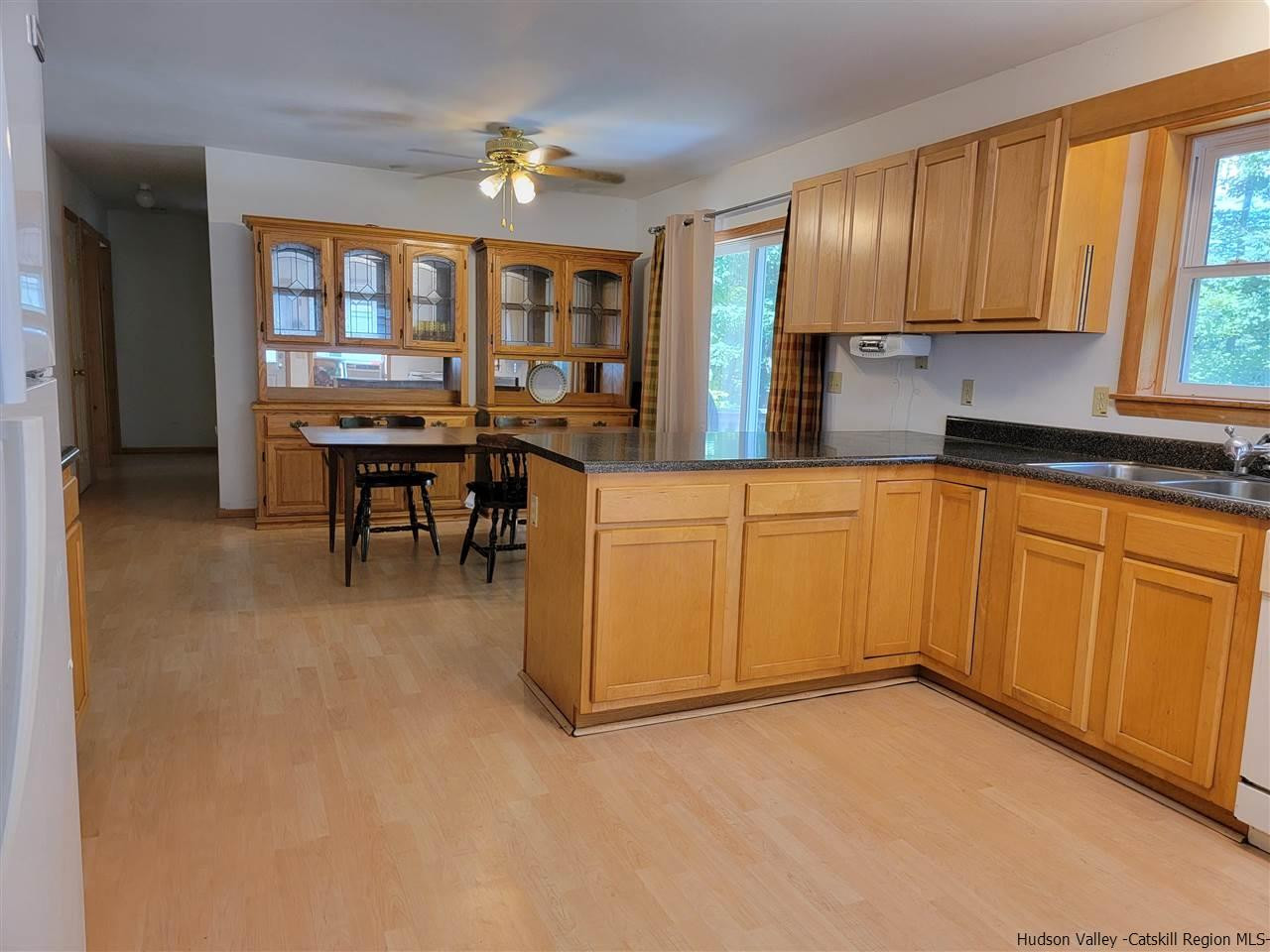 634 Vernal Butler Road Cairo, NY 12413 - Photo 4 of 22 a kitchen with granite countertop a stove a sink a dining table and chairs