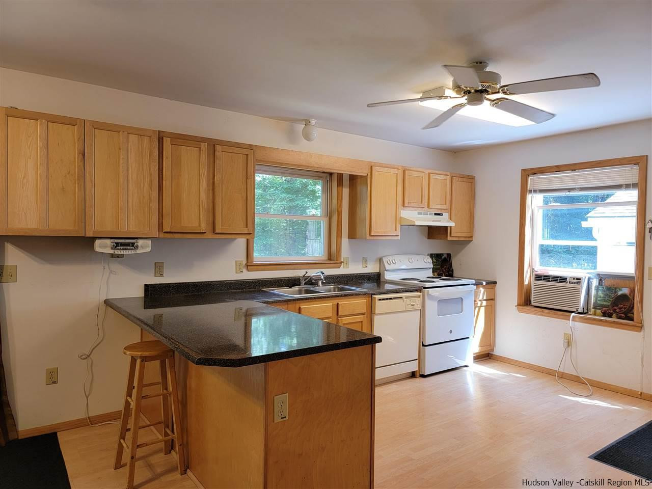 634 Vernal Butler Road Cairo, NY 12413 - Photo 8 of 22 a kitchen with granite countertop a stove sink and microwave