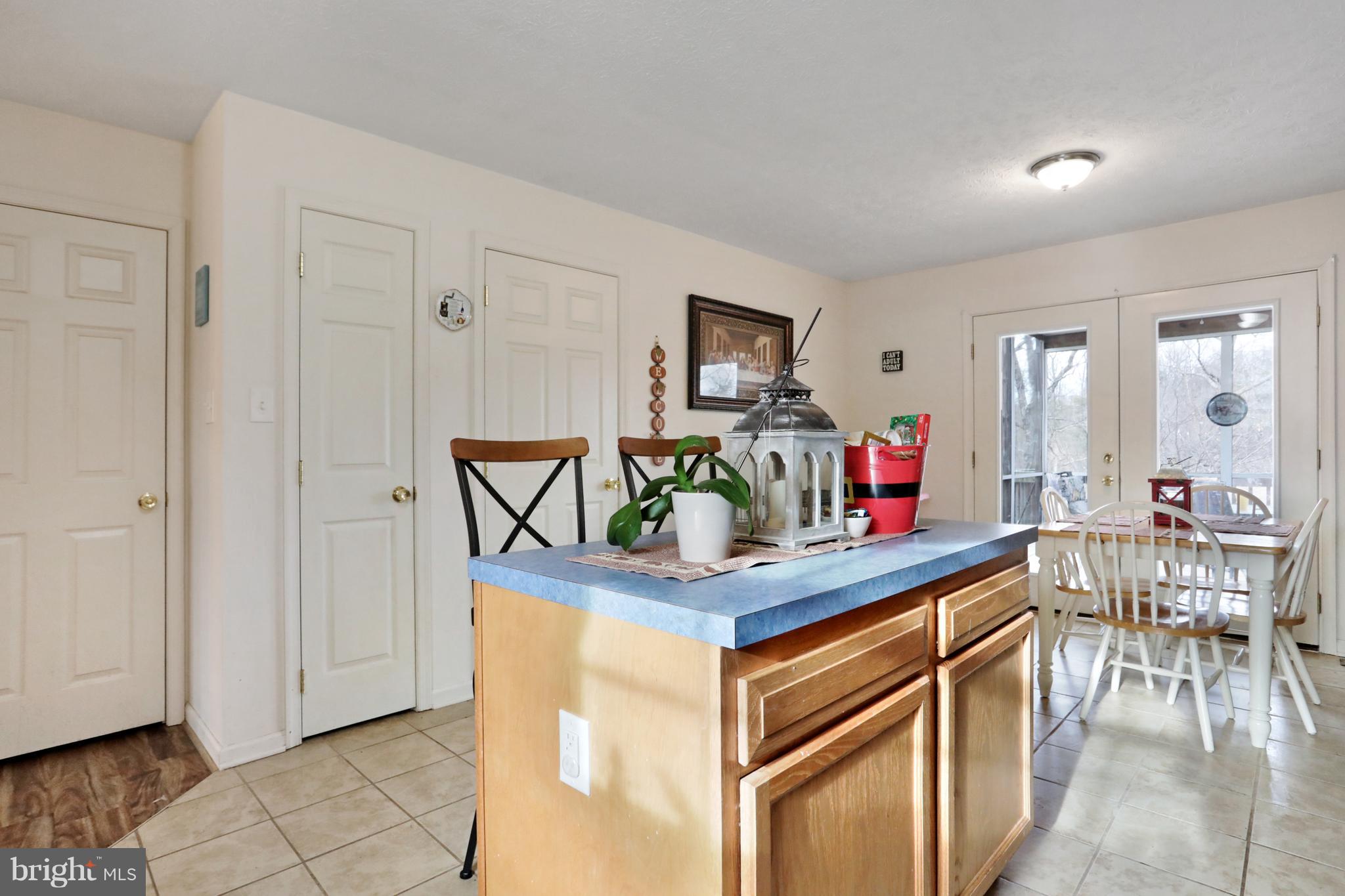 140 Raft Court Inwood, WV 25428 - Photo 11 of 34 a kitchen with stainless steel appliances granite countertop a table and chairs