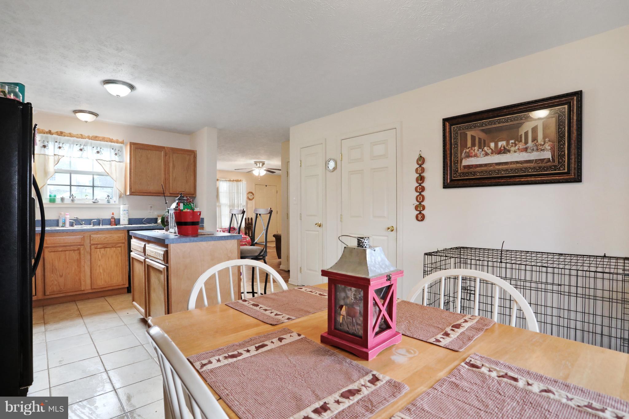 140 Raft Court Inwood, WV 25428 - Photo 14 of 34 a kitchen with a dining table chairs and a refrigerator