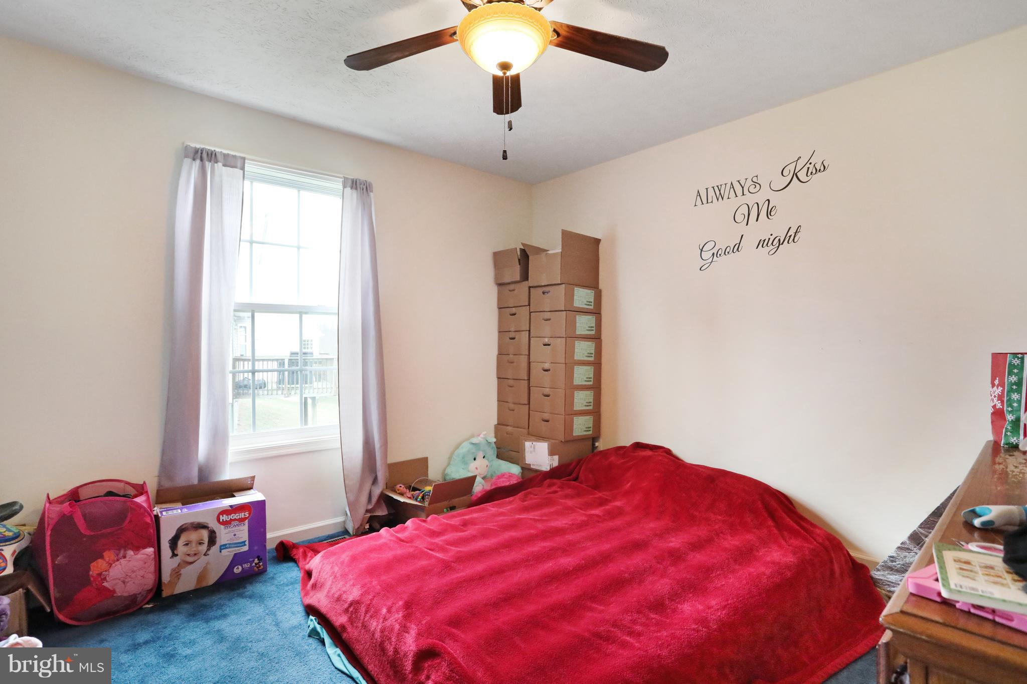 140 Raft Court Inwood, WV 25428 - Photo 18 of 34 a bedroom with a bed and a chandelier
