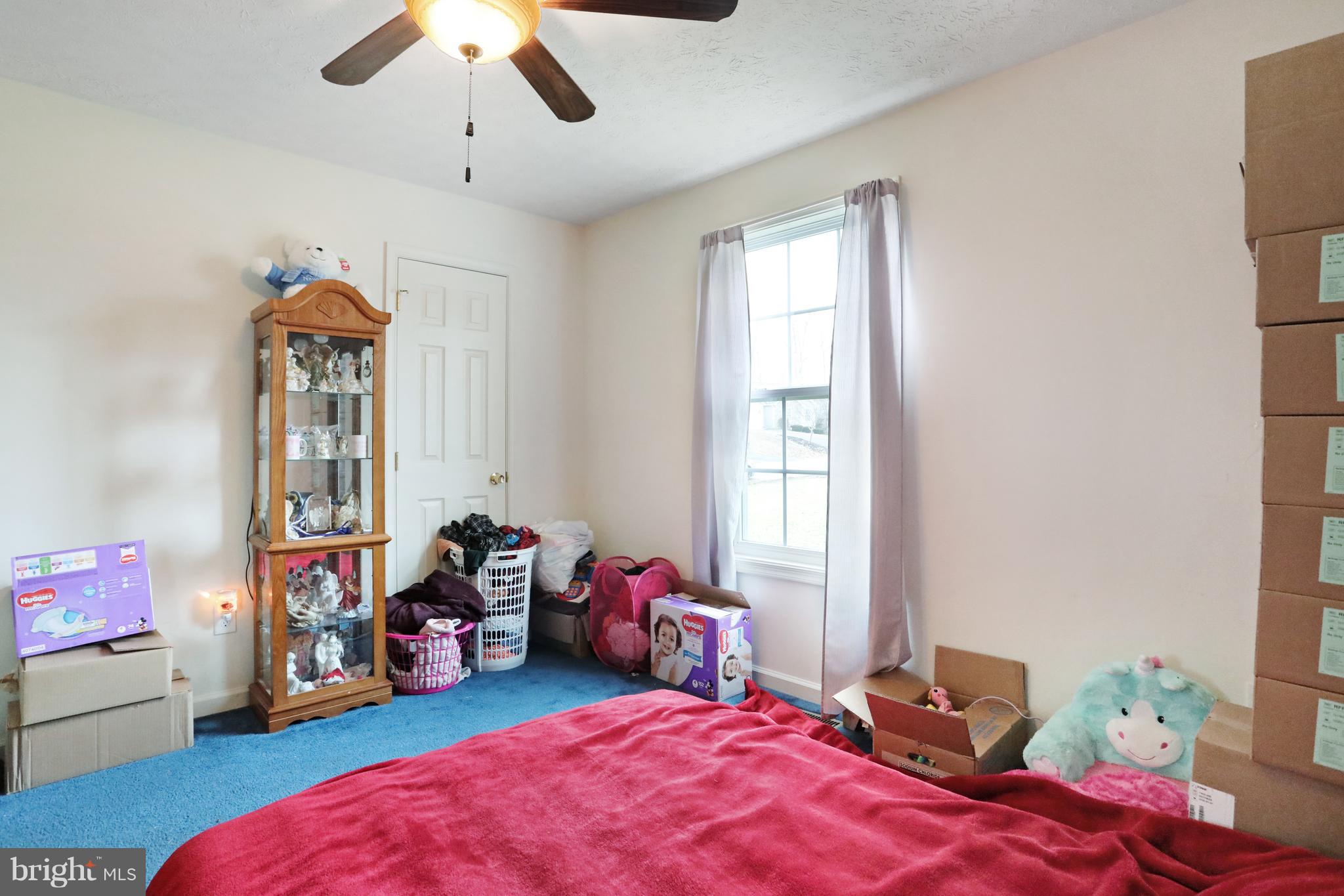 140 Raft Court Inwood, WV 25428 - Photo 19 of 34 a bed room with a bed and a chandelier