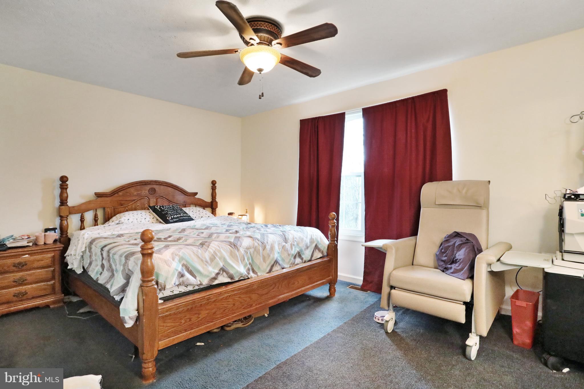 140 Raft Court Inwood, WV 25428 - Photo 21 of 34 a bedroom with a bed and a chandelier