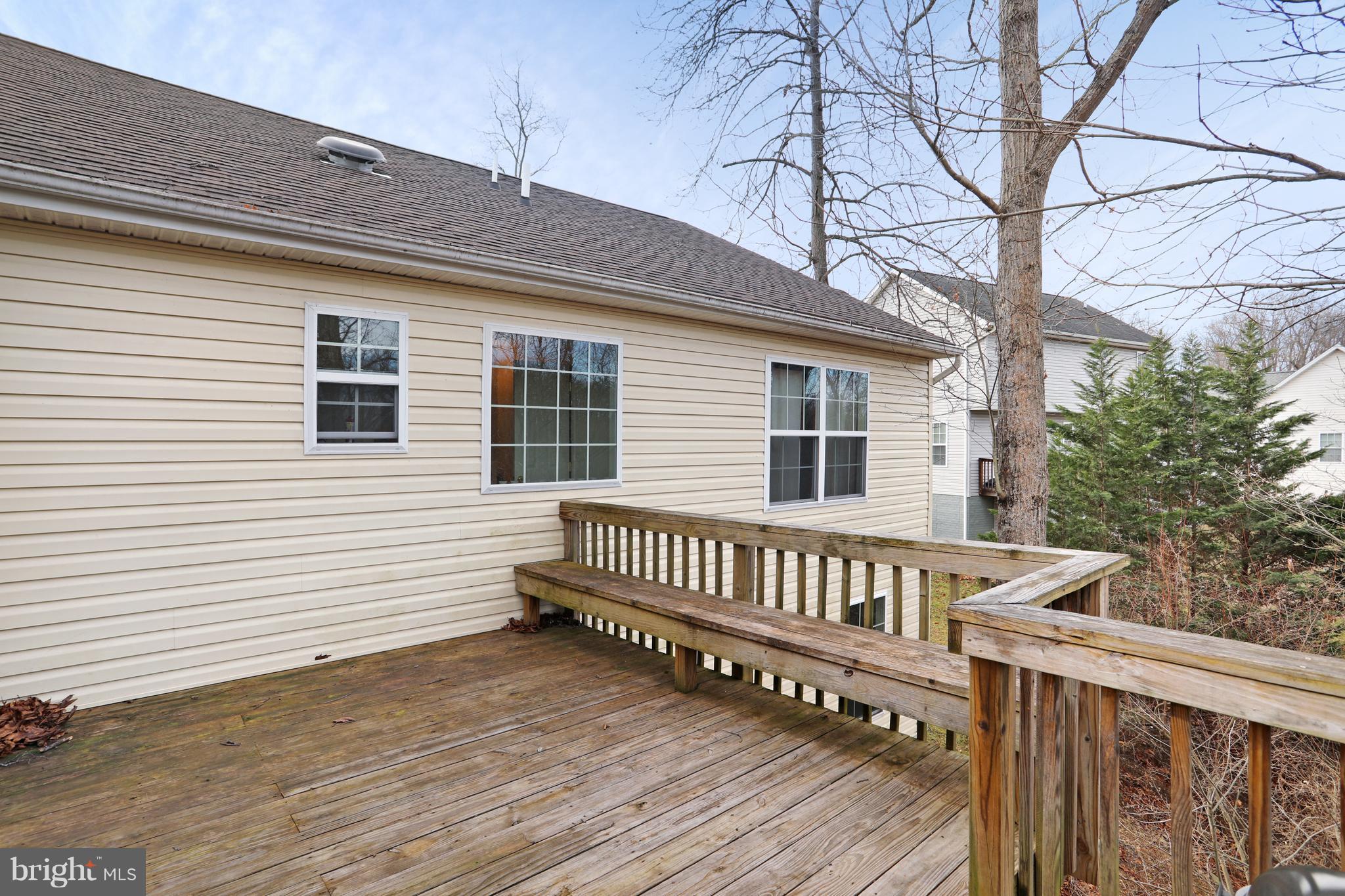 140 Raft Court Inwood, WV 25428 - Photo 32 of 34 a view of a deck with a chair and wooden floor