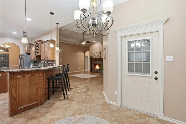 a view of a dining room with furniture and a chandelier