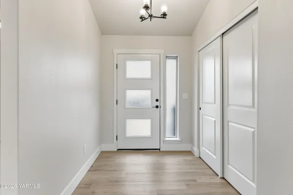 an empty room with wooden floor and mirror