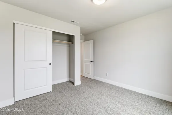 an empty room with closet area