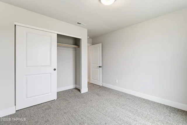 an empty room with closet area