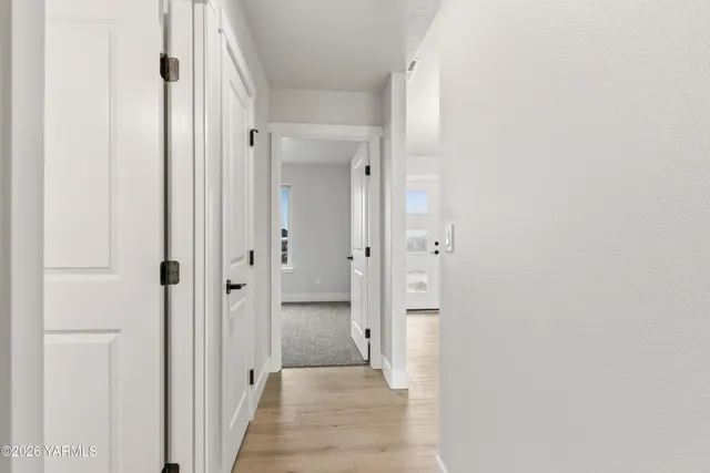 a view of a hallway with a wooden door