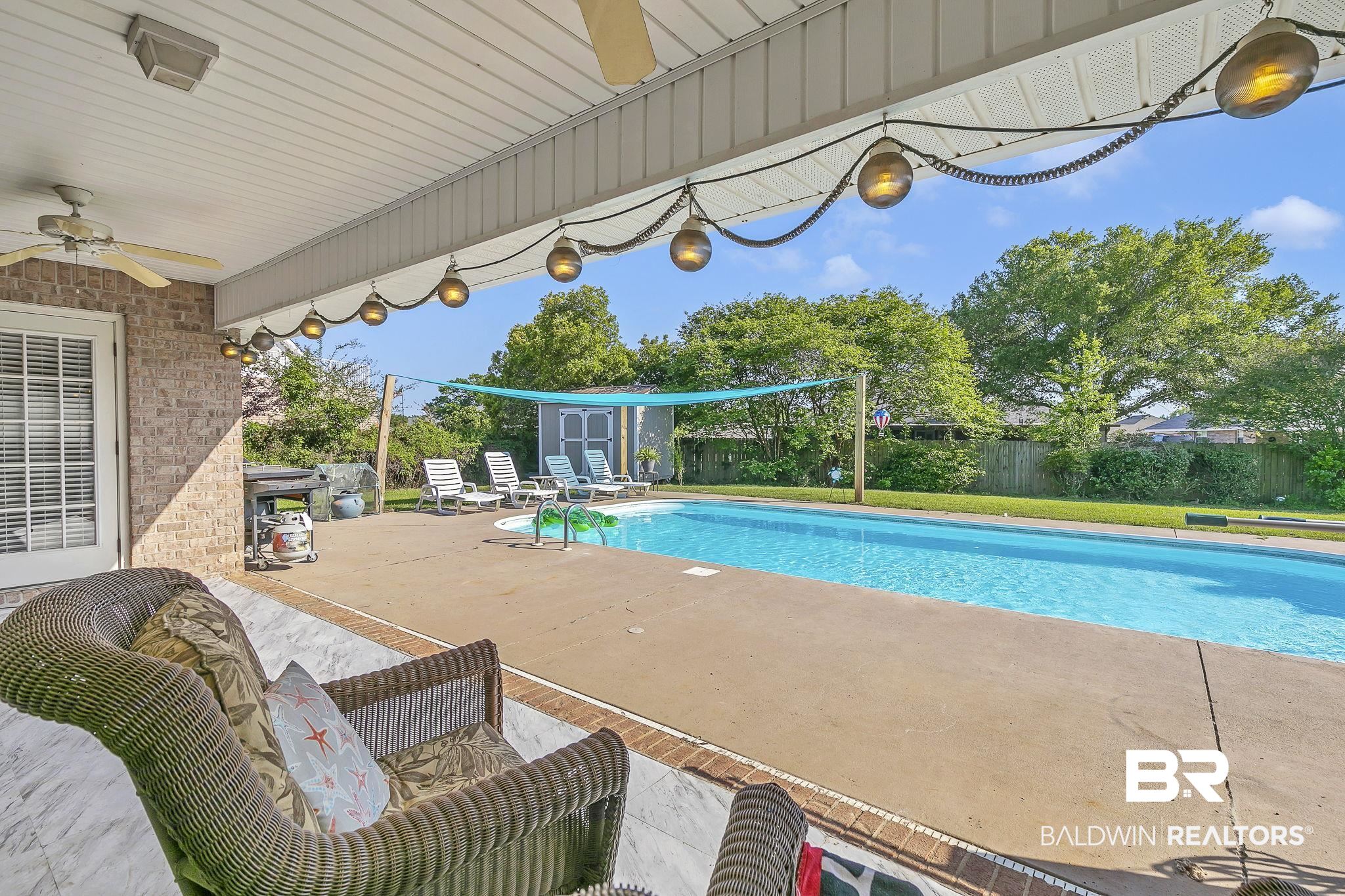 16358 Tempest Drive Foley, AL 36535 - Photo 40 of 46 View of pool with a storage shed, a fenced backyard, a patio area, ceiling fan, and an outdoor structure