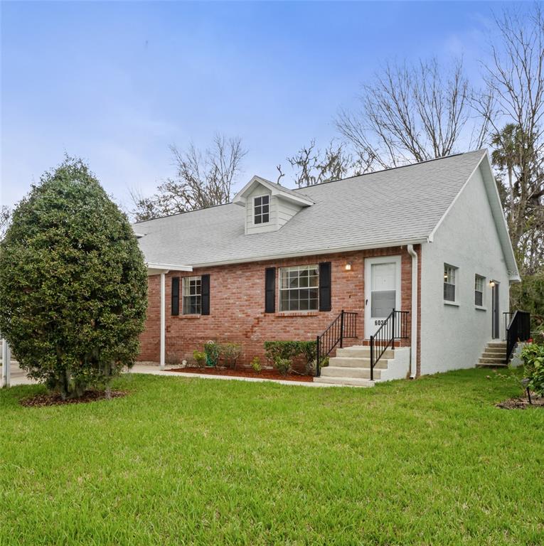 a front view of house with yard and outdoor seating