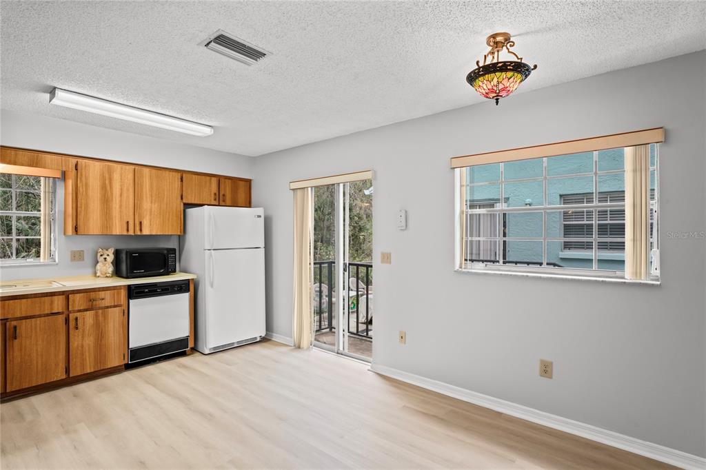 6028 Wilds Drive, Unit 6A New Port Richey, FL 34653 - Photo 11 of 40 a kitchen with stainless steel appliances a refrigerator and a stove