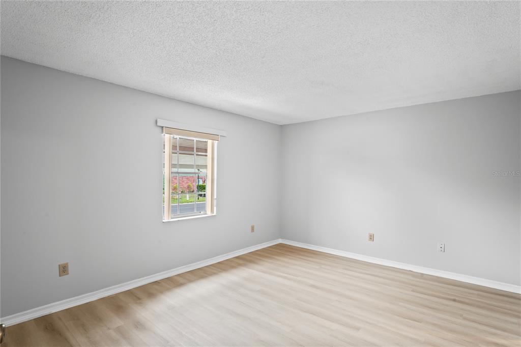 6028 Wilds Drive, Unit 6A New Port Richey, FL 34653 - Photo 12 of 40 wooden floor in an empty room with a window