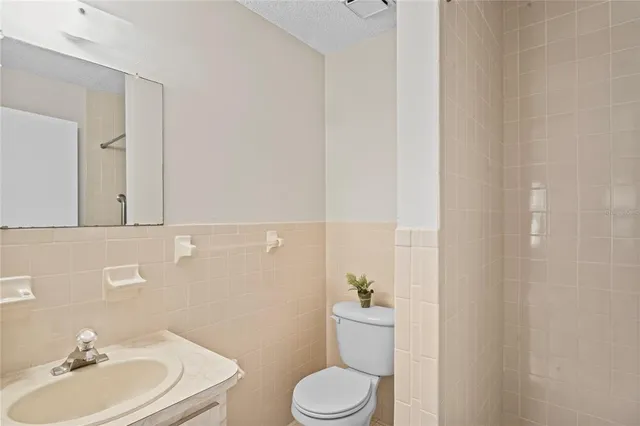 a bathroom with a sink a toilet and mirror