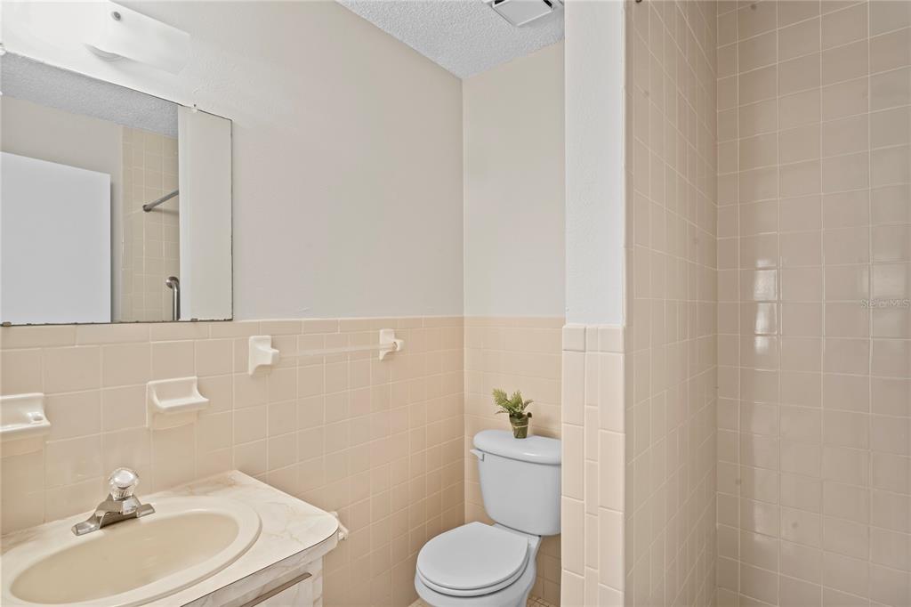 6028 Wilds Drive, Unit 6A New Port Richey, FL 34653 - Photo 16 of 40 a bathroom with a sink a toilet and mirror