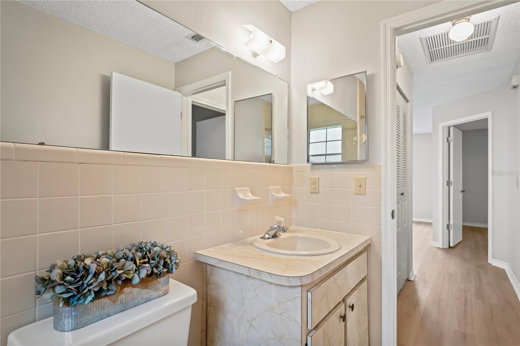 6028 Wilds Drive, Unit 6A New Port Richey, FL 34653 - Photo 22 of 40 a bathroom with a sink and mirror