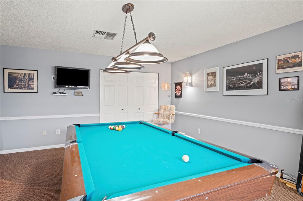 6028 Wilds Drive, Unit 6A New Port Richey, FL 34653 - Photo 29 of 40 a room with pool table and flat screen tv
