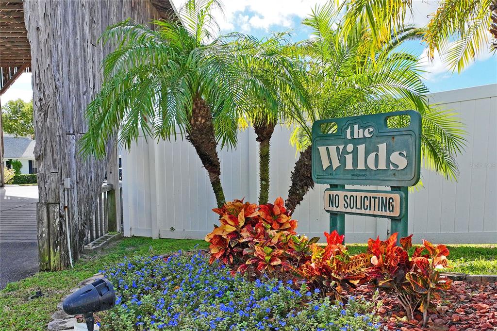 6028 Wilds Drive, Unit 6A New Port Richey, FL 34653 - Photo 34 of 40 a sign that is next to a road