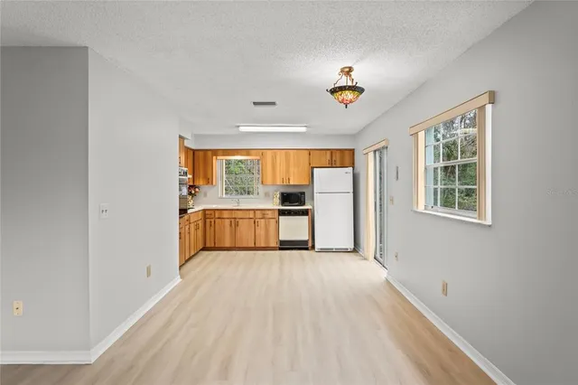 a view of a kitchen with a sink cabinet and a window