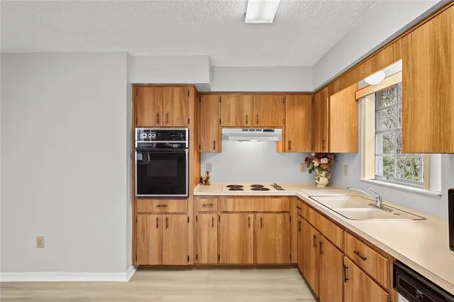 a kitchen with a sink stove and cabinets