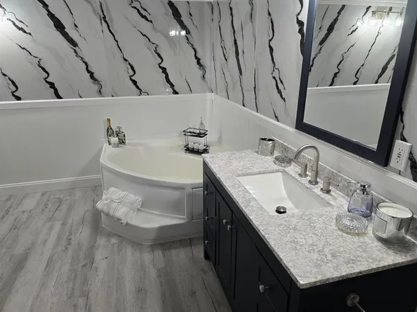 a bathroom with a double vanity sink and a mirror