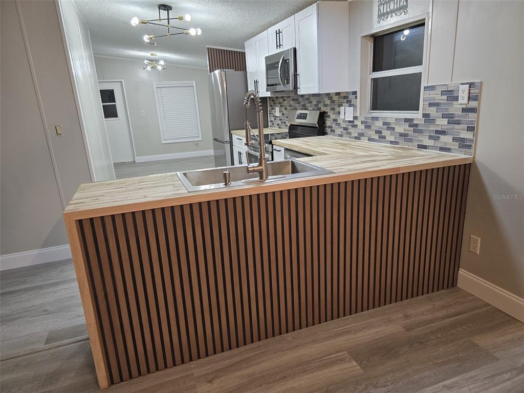 3700 West Highway 316 Reddick, FL 32686 - Photo 22 of 39 a kitchen with a sink and cabinets