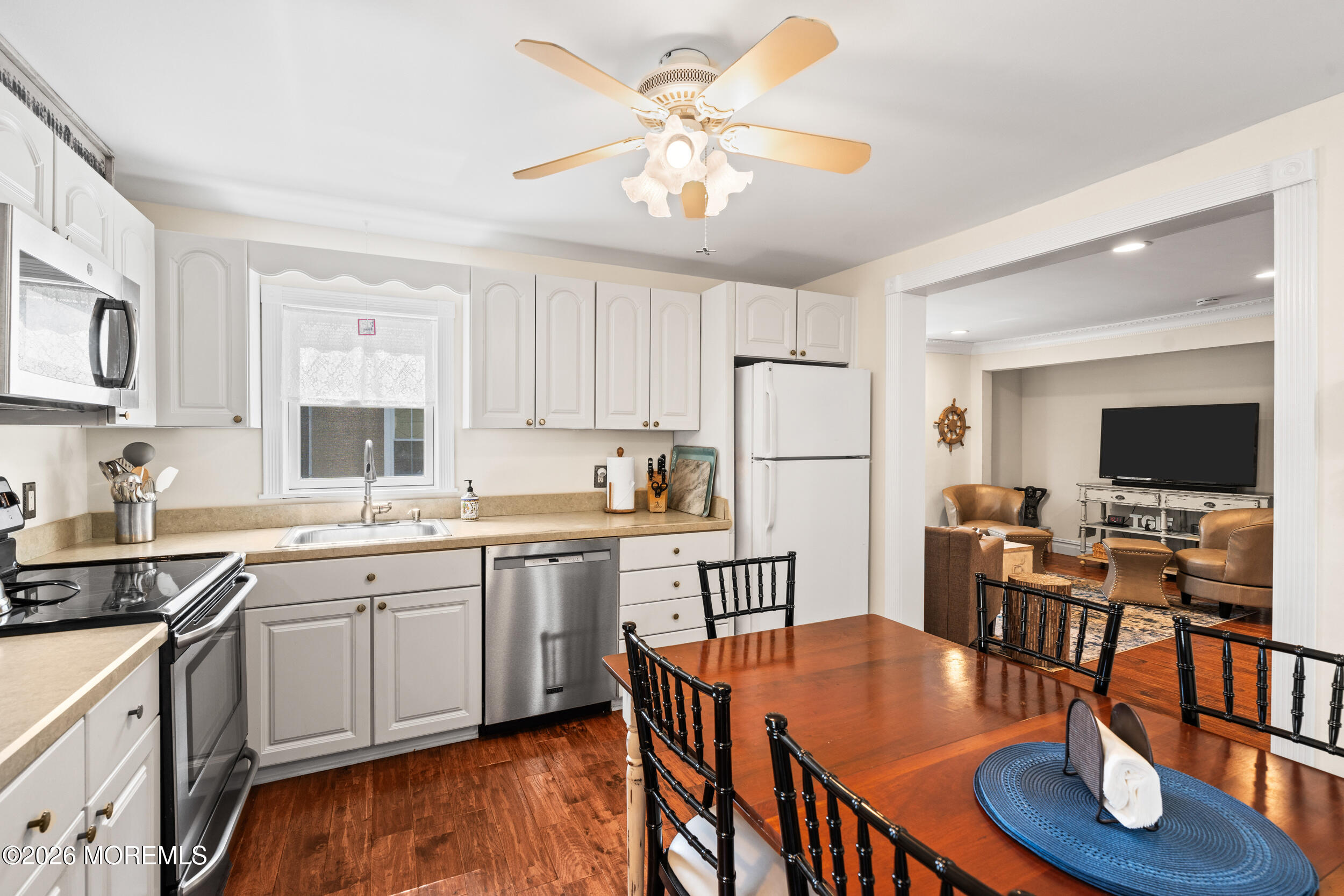 75 Webb Avenue, Unit UPPER WEEKLY Ocean Grove, NJ 07756 - Photo 16 of 41 a kitchen with stainless steel appliances granite countertop a dining table and chairs